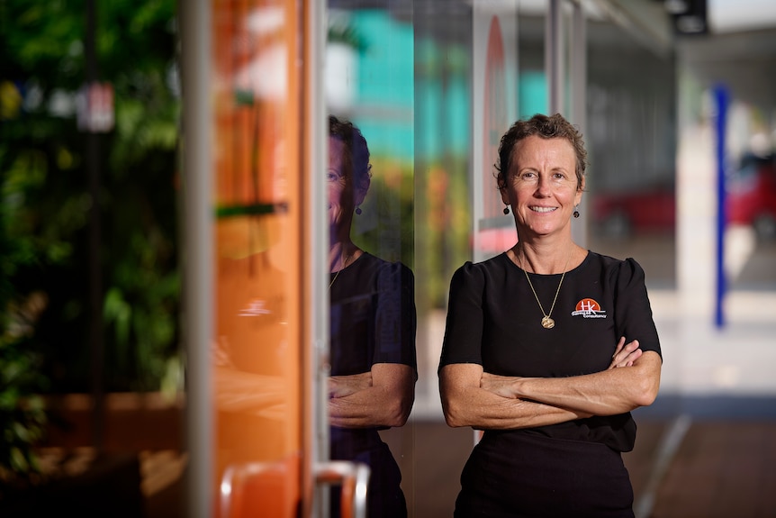 Toni Cork stands with her arms crossed.