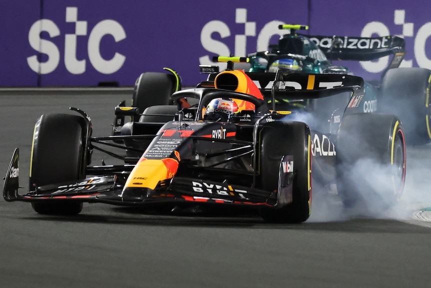Sergio Perez makes the move on Fernando Alonso for the lead of the race, locking his front tyres and causing smoke