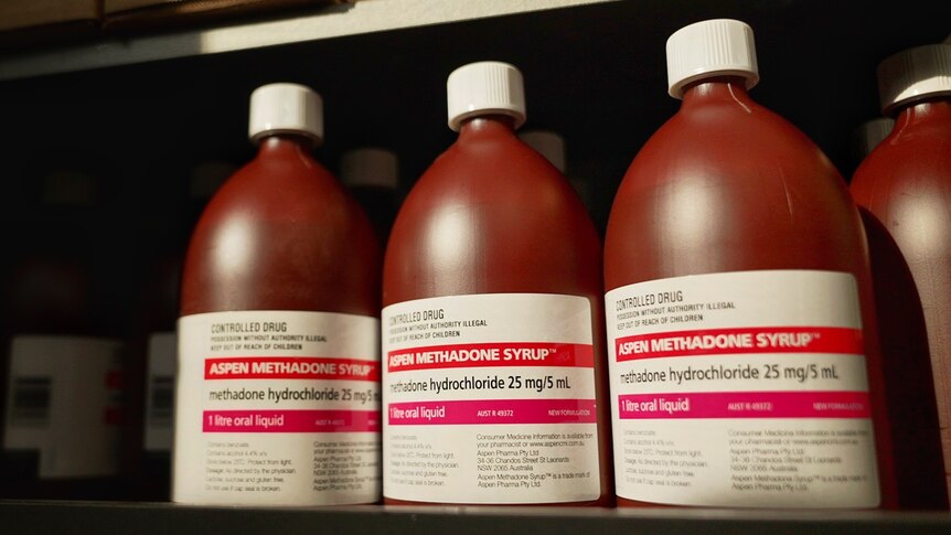 Brown bottles of Aspen Methadone Syrup lined up on a shelf
