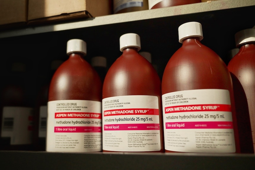 Brown bottles of Aspen Methadone Syrup lined up on a shelf