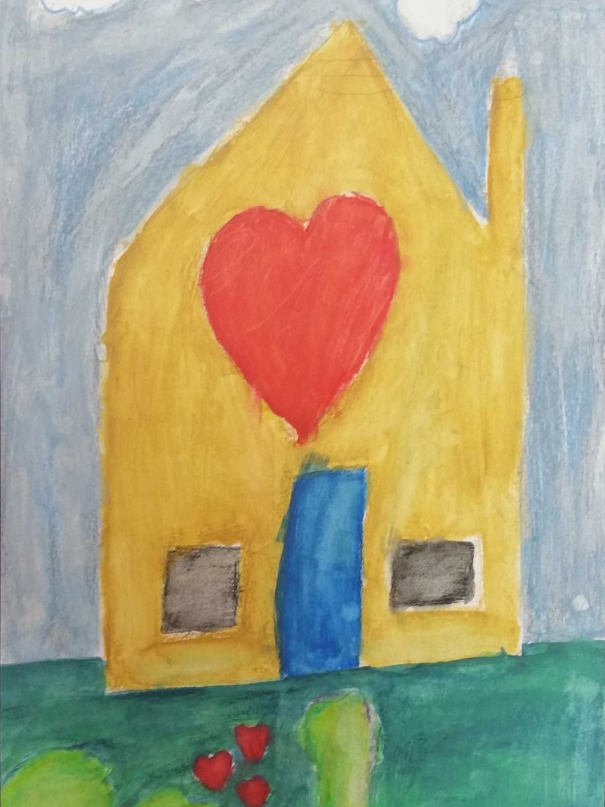 Hand-drawn picture by a primary school student of a yellow house with a big red love heart in the middle.