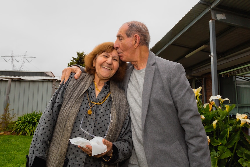 Shaker and Shameran hug as they stand in their backyard.