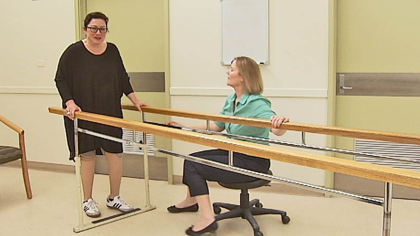 Gill Hicks tries her newest artificial legs under Sally Cavenett's expert eye