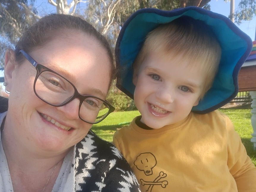 A mother and son smile. 