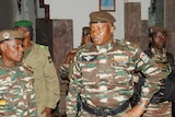Abdourahmane Tiani in military gear surrounded by four other men also in army uniform. 