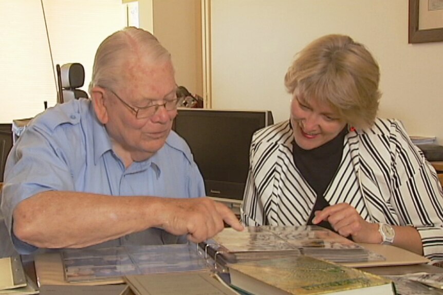 Peter Mussared and his daughter Jane look at photos