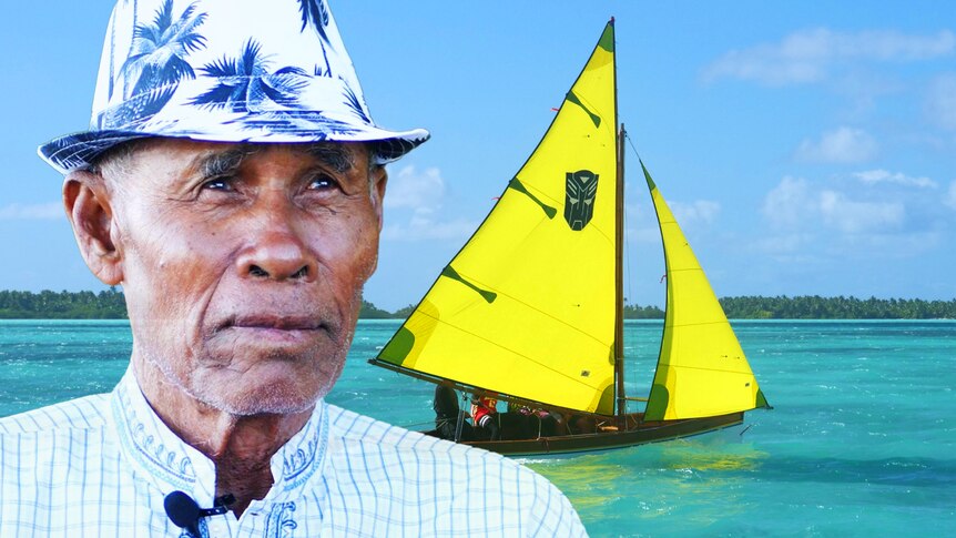 A Cocos Malay man wearing a hat looks pensively up, a yacht with yellow sails on tropical blue water in the background.