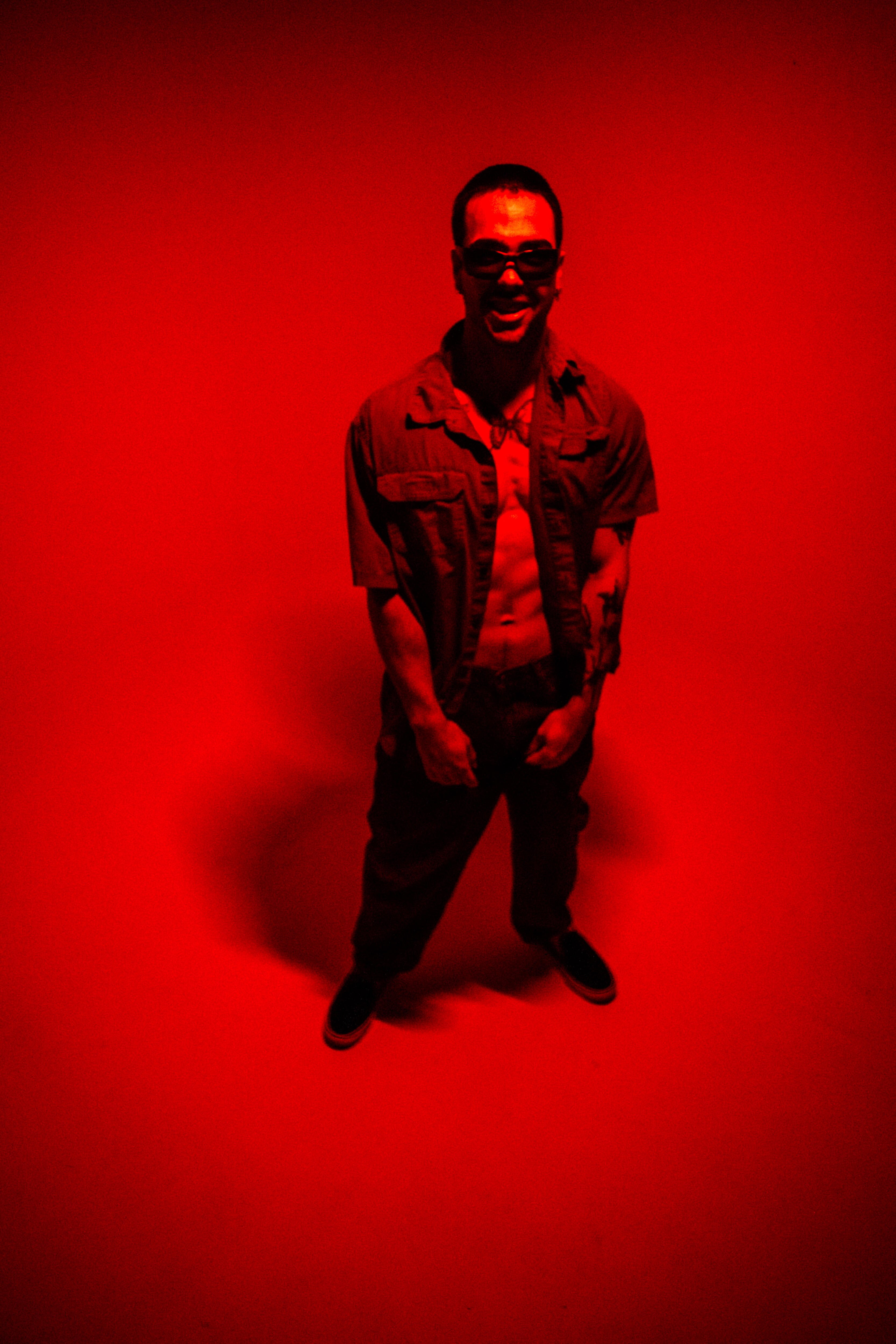 an image somber hills standing in a red room wearing red clothes