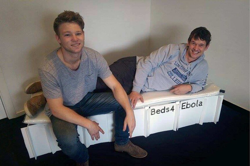 Lincoln Williams and Hamish Cowie sitting on a disposable bed they designed.