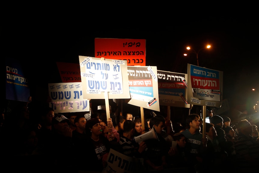 Israelis take part in a protest against violence by religious zealots near Jerusalem