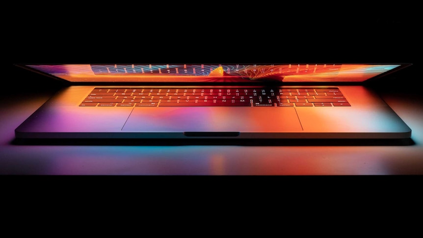 A laptop in the dark.