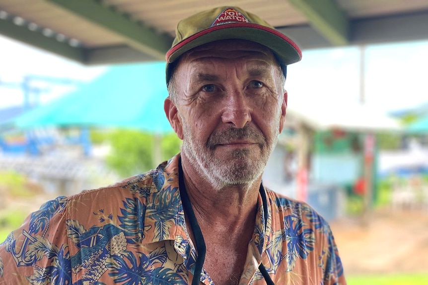 A man standing on the balcony of a yacht club