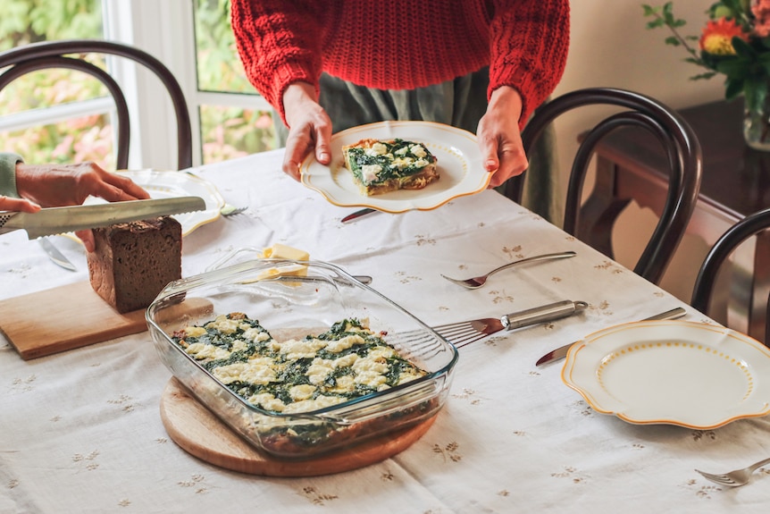 Heidi Sze serves a piece of her baked frittata with potato and silverbeet.