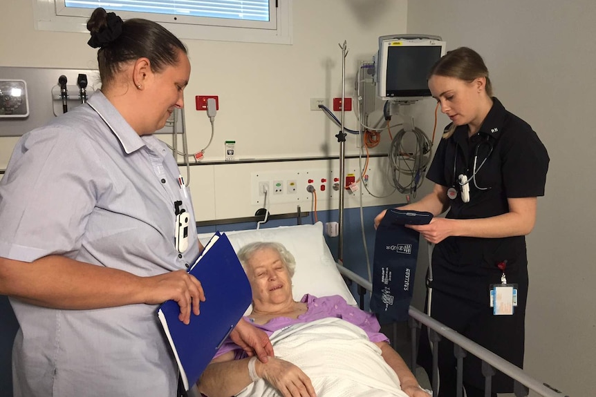 Registered nurses Shari St John and Carly Clunes and a patient.