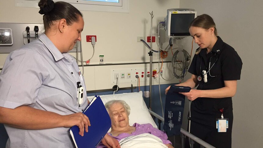 Registered nurses Shari St John and Carly Clunes and a patient.