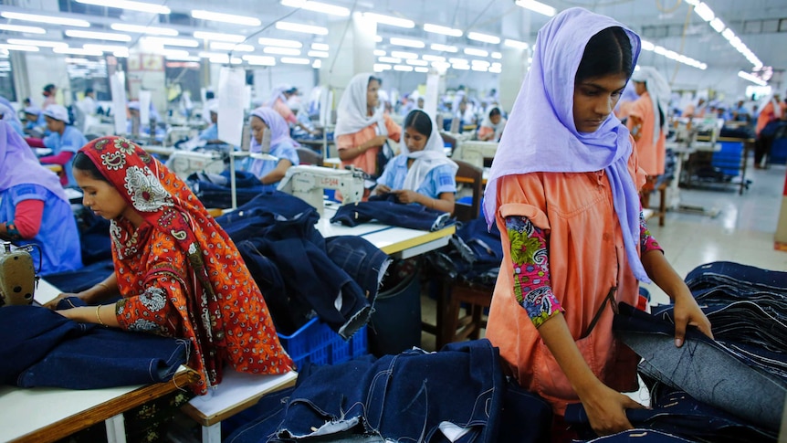 Workers sort clothes at a garment factory in Bangladesh.