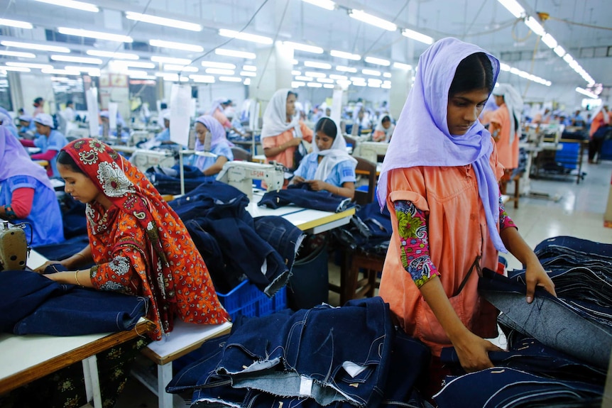 Workers sort clothes at a clothing factory near the collapsed Rana Plaza building in Savar, Bangladesh