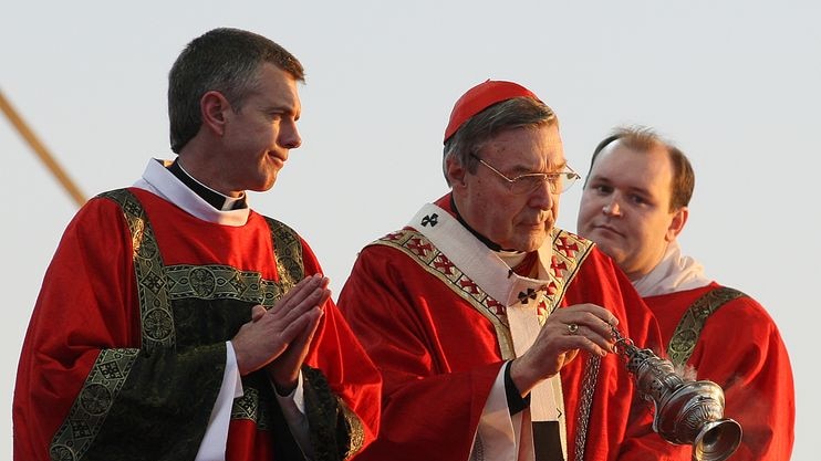 Cardinal George Pell (C) blesses the altar with incense
