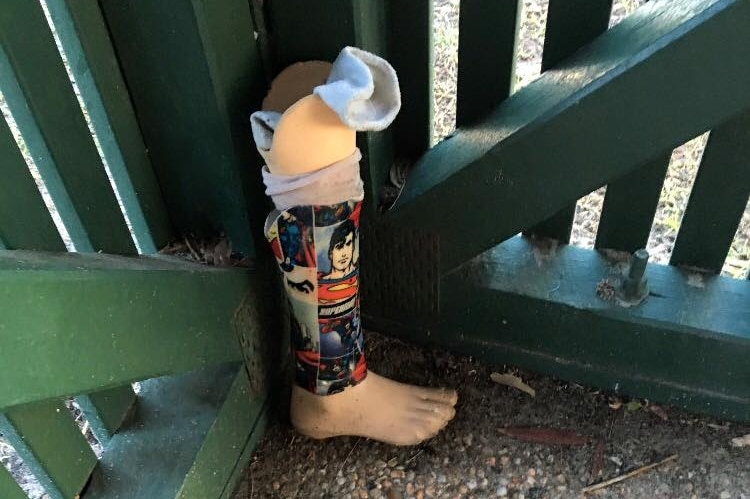 Child's Superman-themed prosthetic leaning against a wall