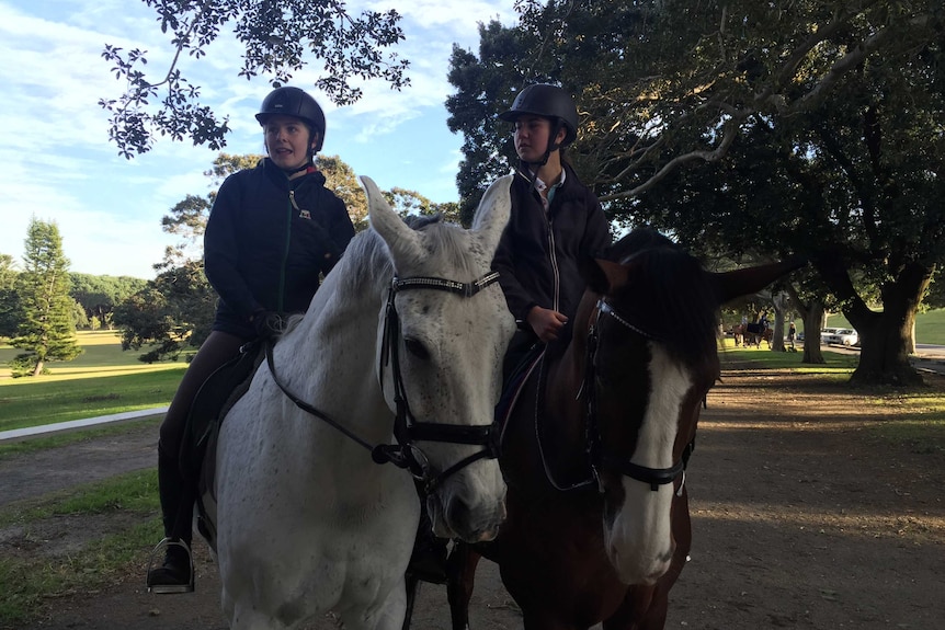 Jessie O'connell and Sophia Evestigneev sitting on their horses.
