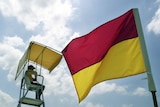 A surf lifesaver keeps watch