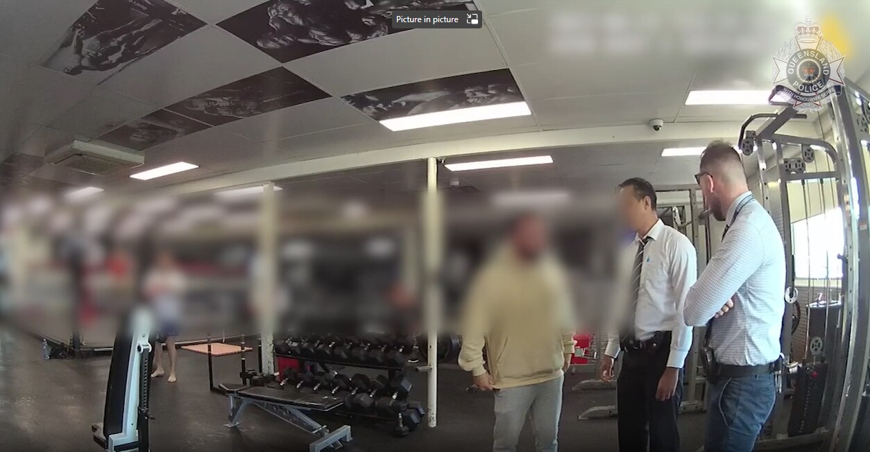 Detectives question a man at a Brisbane gy
