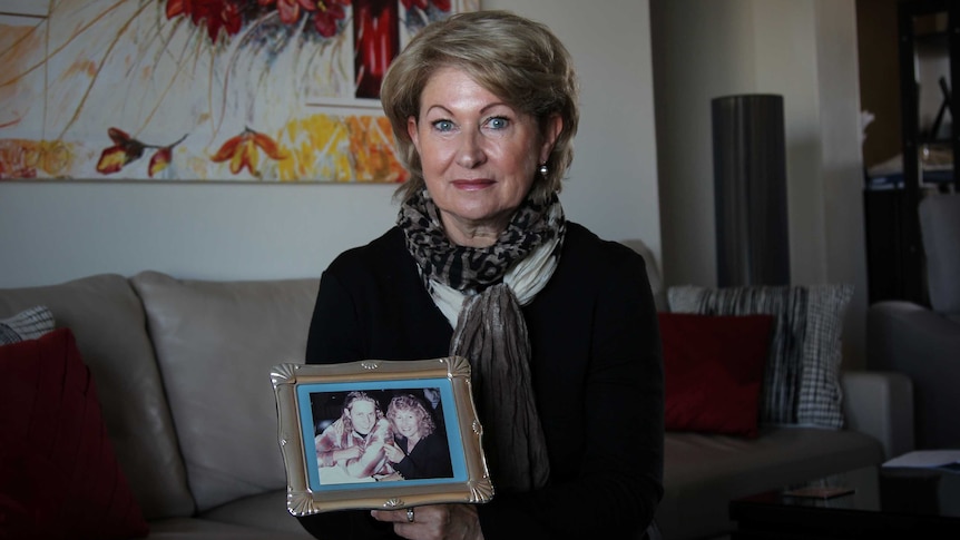 Sally Wilkinson holding an old photograph