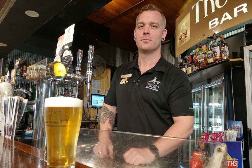 Criterion Hotel general manager Jay Hill in Rockhampton behind the bar.