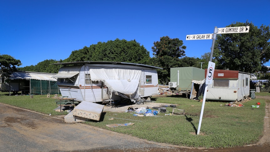 Damaged caravans with rubbish piles
