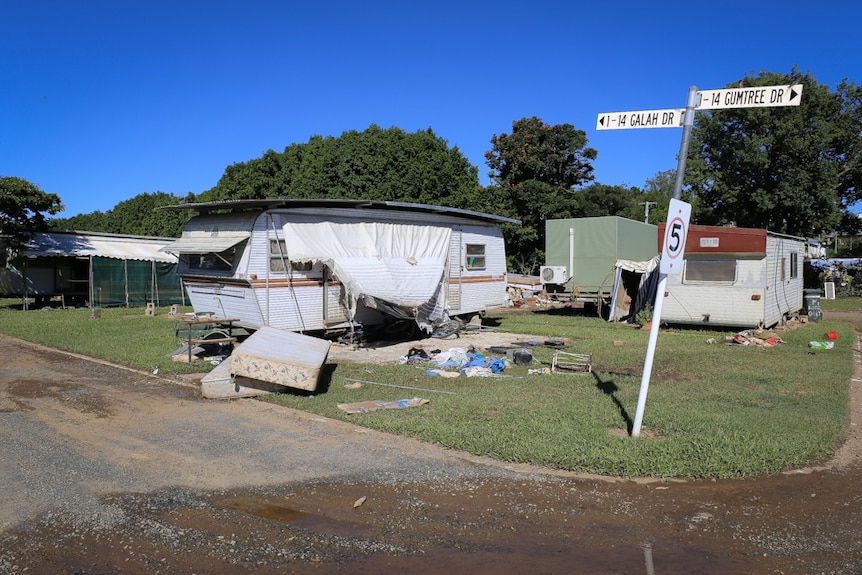 Damaged caravans with rubbish piles