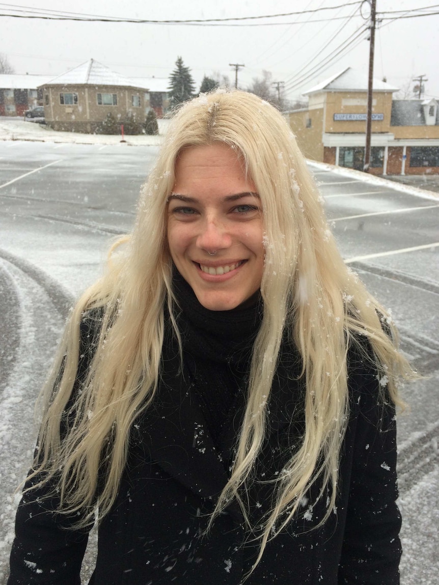 Shelley Wakefield smiles while rugged up and experiencing snow in New York
