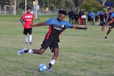 Brisbane United striker Zaki Ahmed taking a shot at goal.