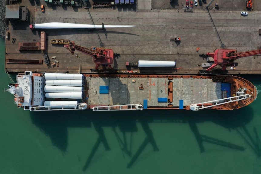 An aerial view of a ship carrying wind turbines.