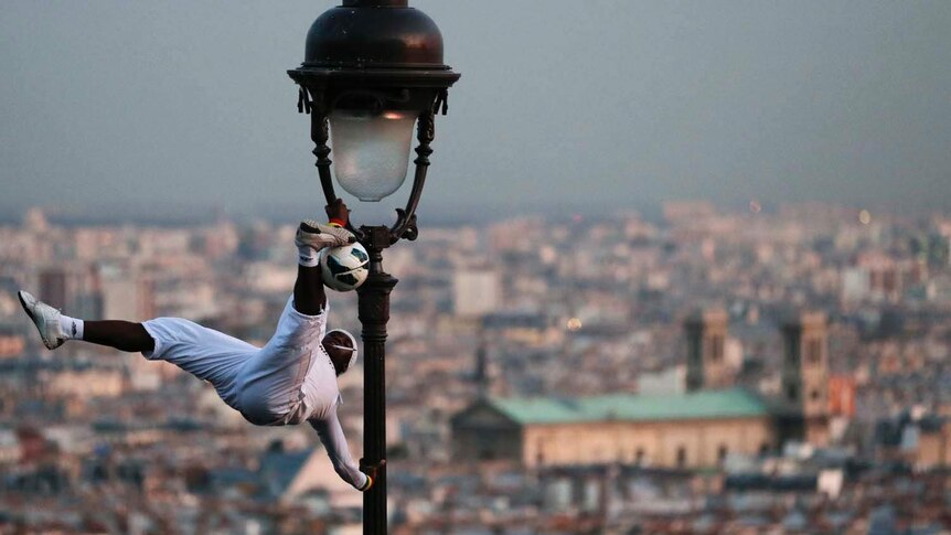 A soccer freestyler performs in Paris
