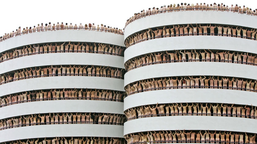 Naked volunteers pose in the Europarking building in Amsterdam