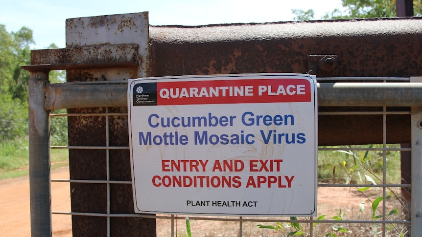 a quarantine sign on a gate