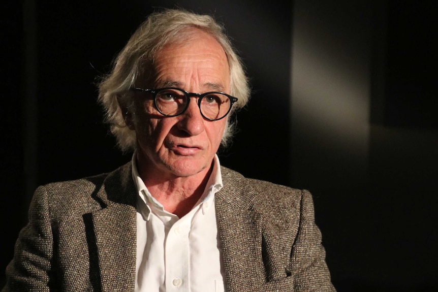 Professor David Harries wearing glasses, a white shirt and tweed jacket.