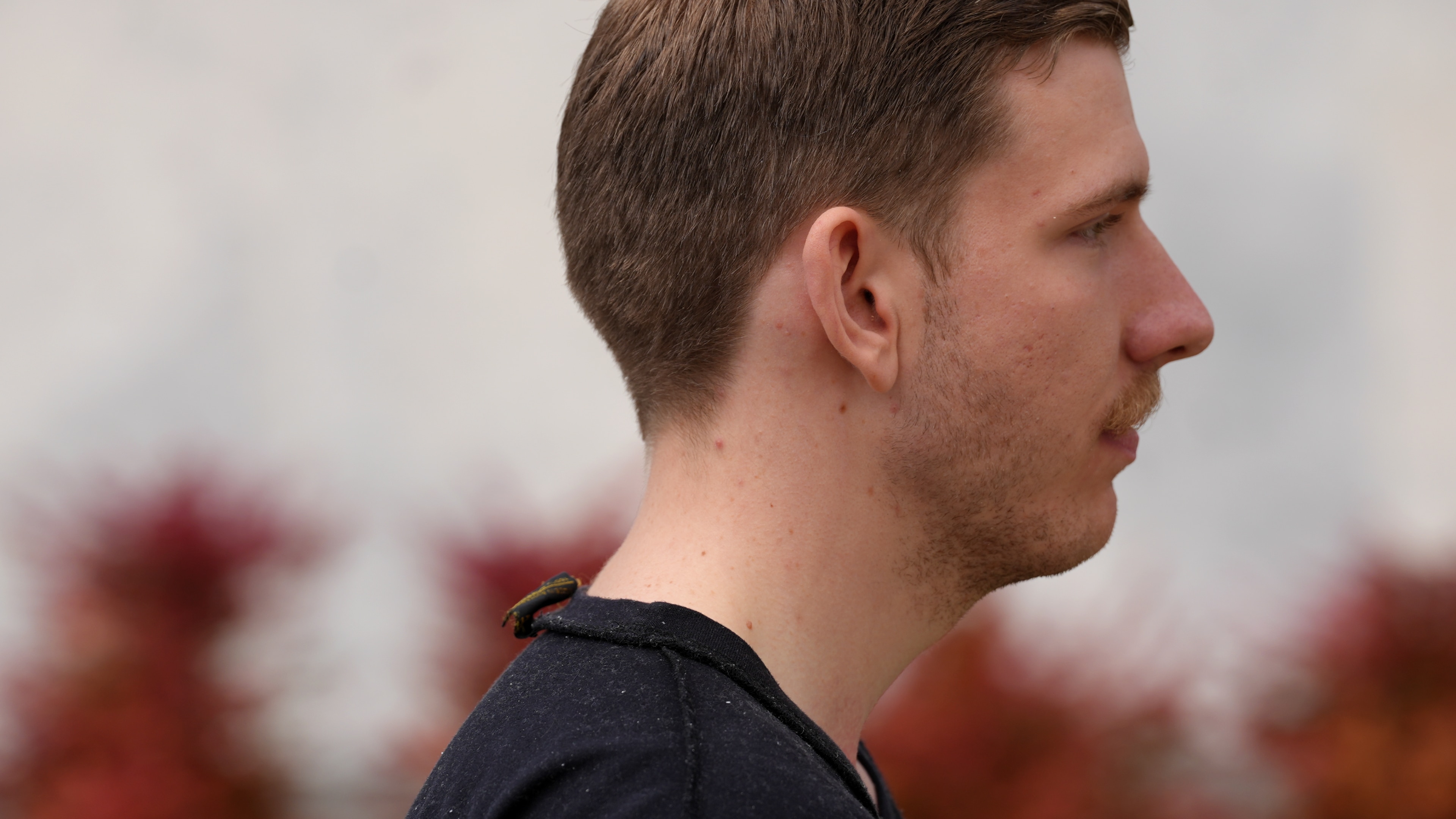 A man with close-cropped light hair seen from the side.