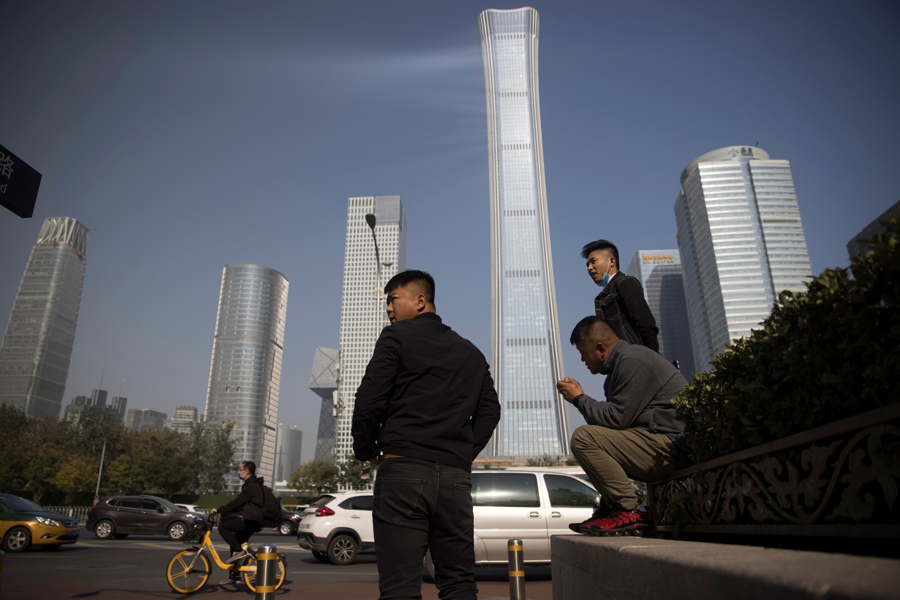 A generic photo of a city skyline with a few men standing in the foreground.