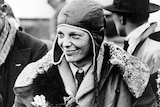 American aviatrix Amelia Earhart poses with flowers as she arrives in Southampton.