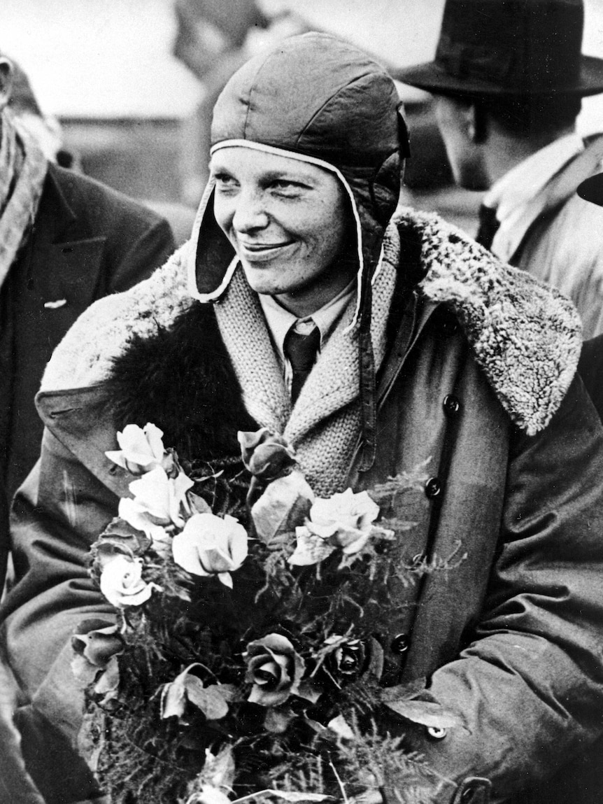 American aviatrix Amelia Earhart poses with flowers as she arrives in Southampton.