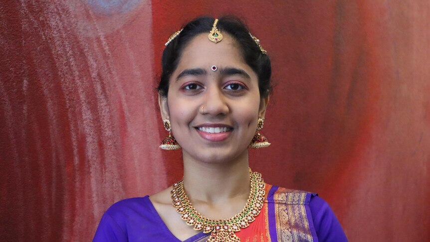 Girl with traditional Kuchipudi (Indian dance) costume, smiling.
