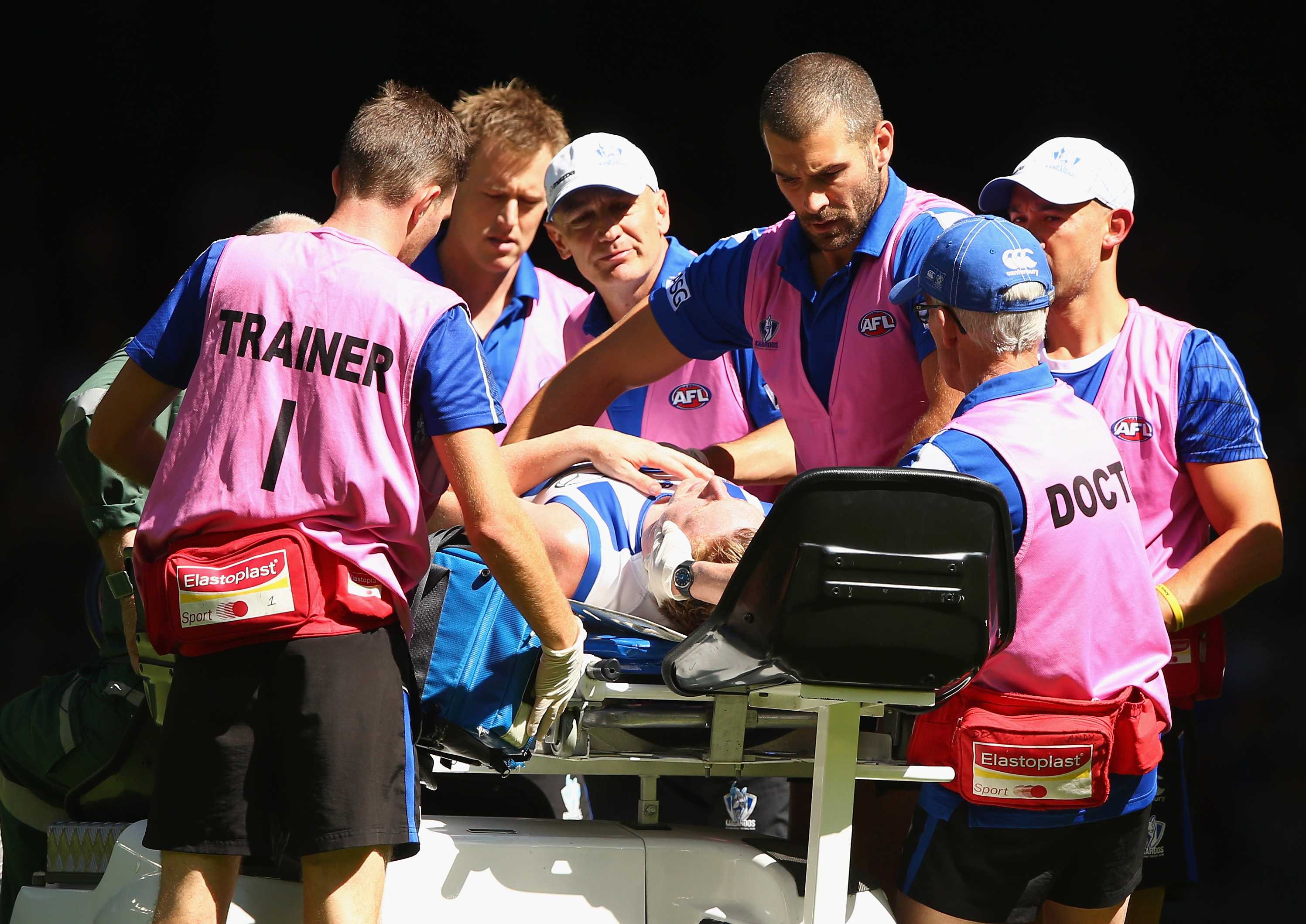 North Melbourne's Jack Ziebell is stretchered off after being knocked out against Richmond.