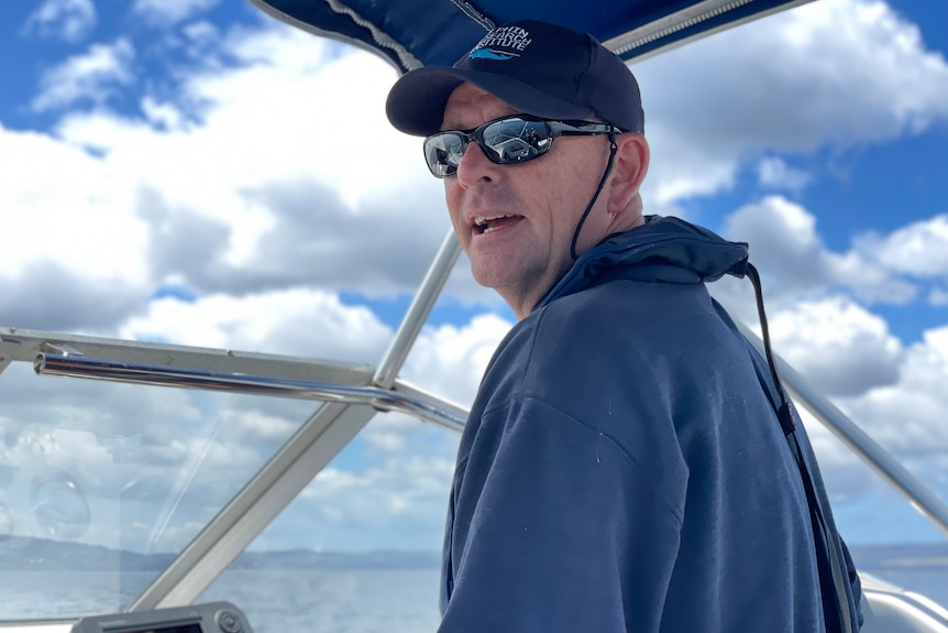 A man steering a boat.