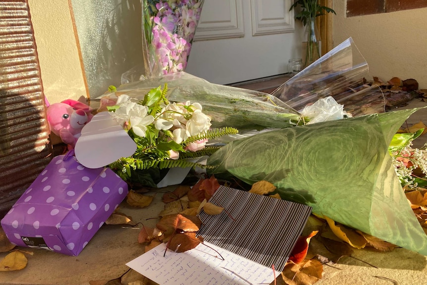 Flowers and cards in front of a door