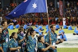 Erika Yamasaki holds the Australian flag and leads the Australian team at the opening ceremony