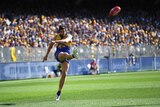 Josh Kennedy in action kicking the football for West Coast against Melbourne at Perth Stadium.