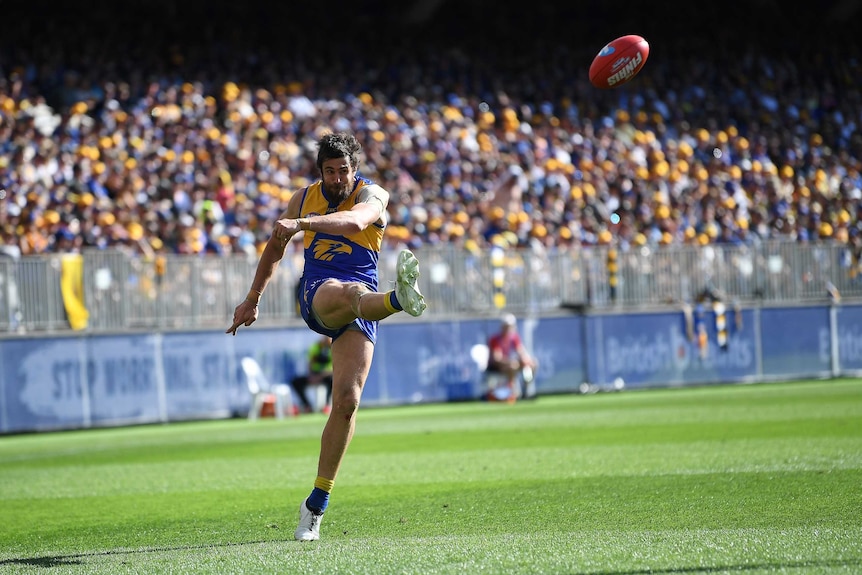 Josh Kennedy in action kicking the football