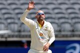 Nathan Lyon holds up his hand