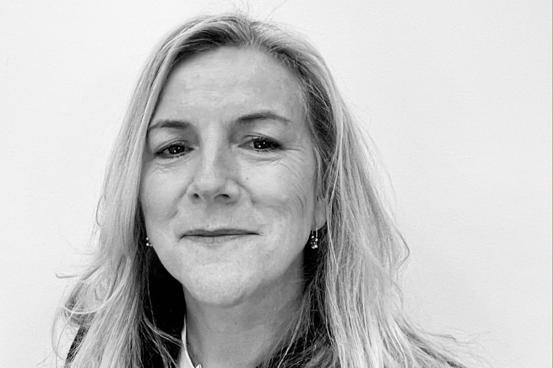 A black and white corporate headshot of a woman.